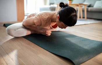 Close up of a Young Japanese woman doing yoga at home